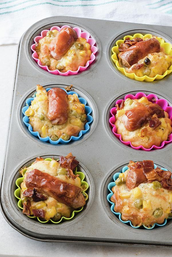 A Metal Muffin Tray With Savoury Frankfurter Sausage Muffins In Colourful Silicone Cases. Crispy Bacon, Corn And Green Peas Photograph by Edyta Girgiel