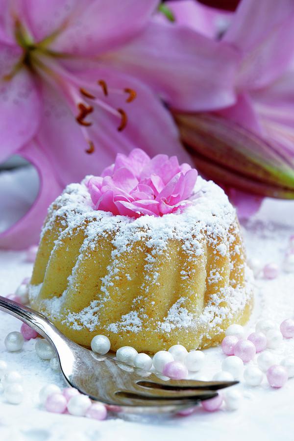 A Mini Bundt Cake With Icing Sugar And Flower Decoration Photograph by Angelica Linnhoff