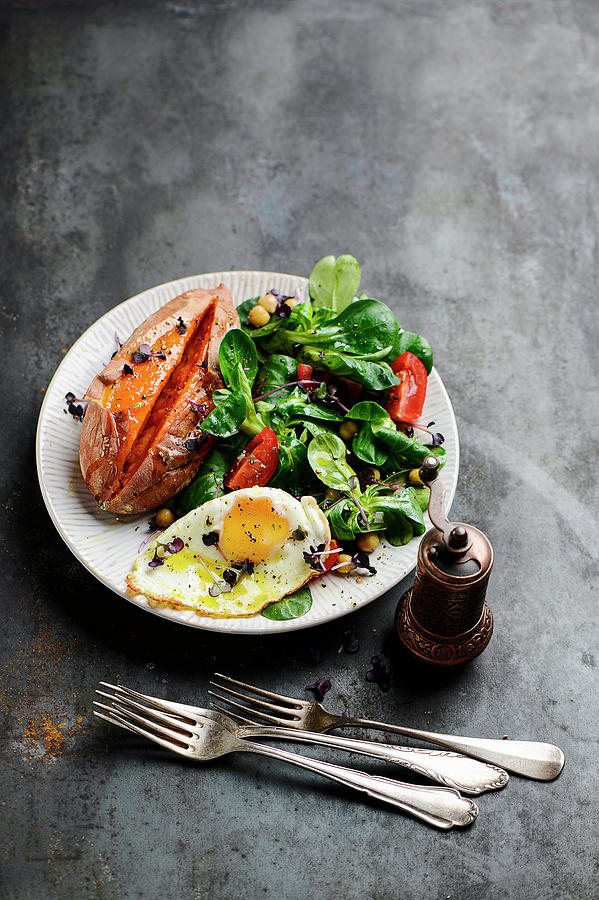A Mixed Salad With A Fried Egg And Roasted Sweet Potatoes Photograph by Ewgenija Schall