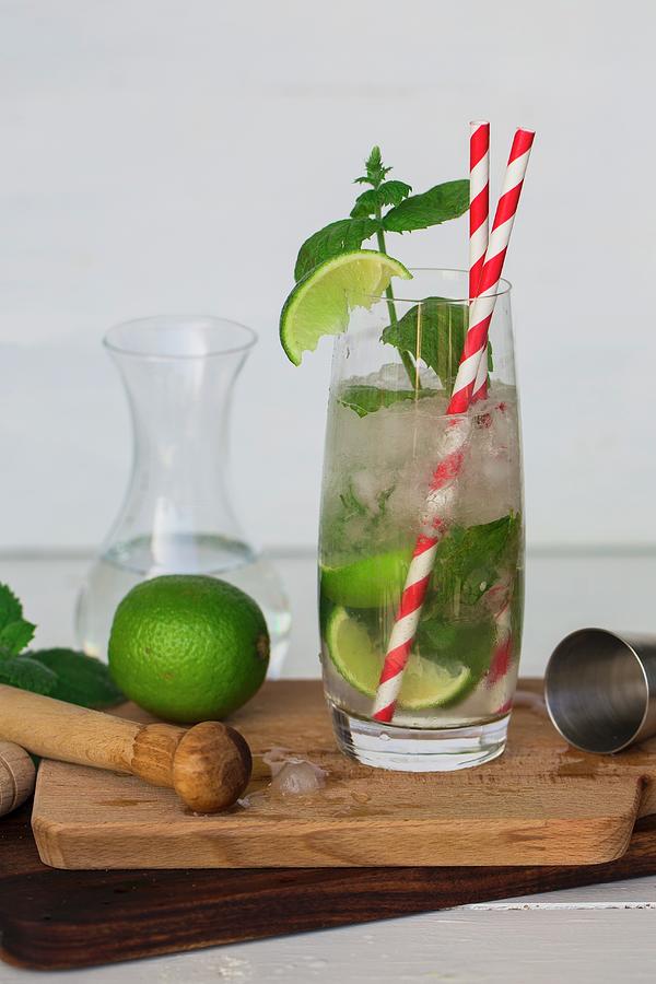 A Mojito With Limes, Mint And Straws Photograph by Nicole Godt