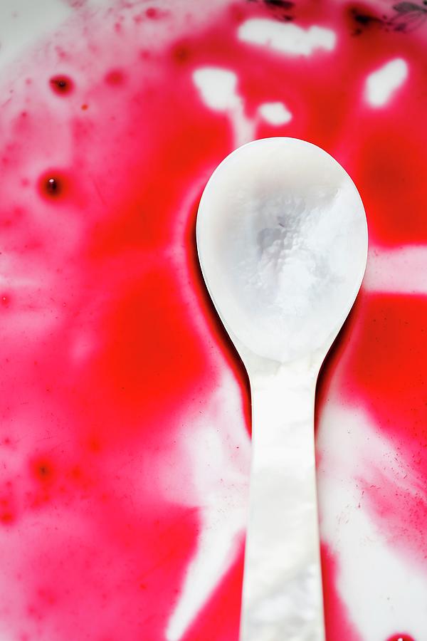 A Mother-of-pearl Spoon In Red Grape Juice Photograph by Sandra Krimshandl-tauscher