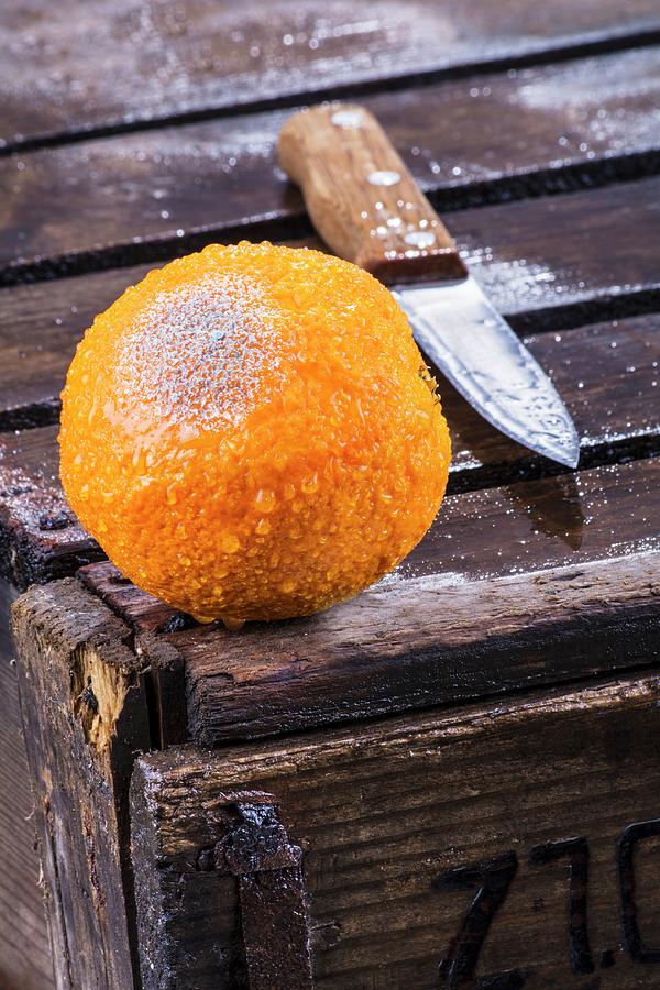 A Mouldy Orange With A Knife On A Wooden Crate Photograph by Chris Schfer