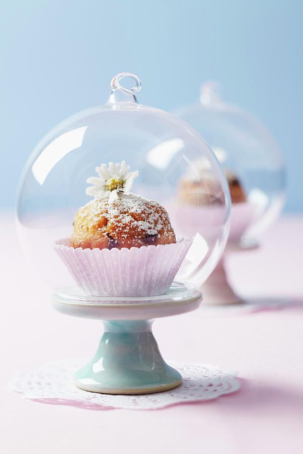 A Muffin Under A Cloche On A Mini Cake Stand On A Doily Photograph by Franziska Taube