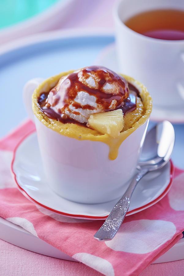 A Mug Cake With Pineapple A Scoop Of Ice Cream And Chocolate Sauce