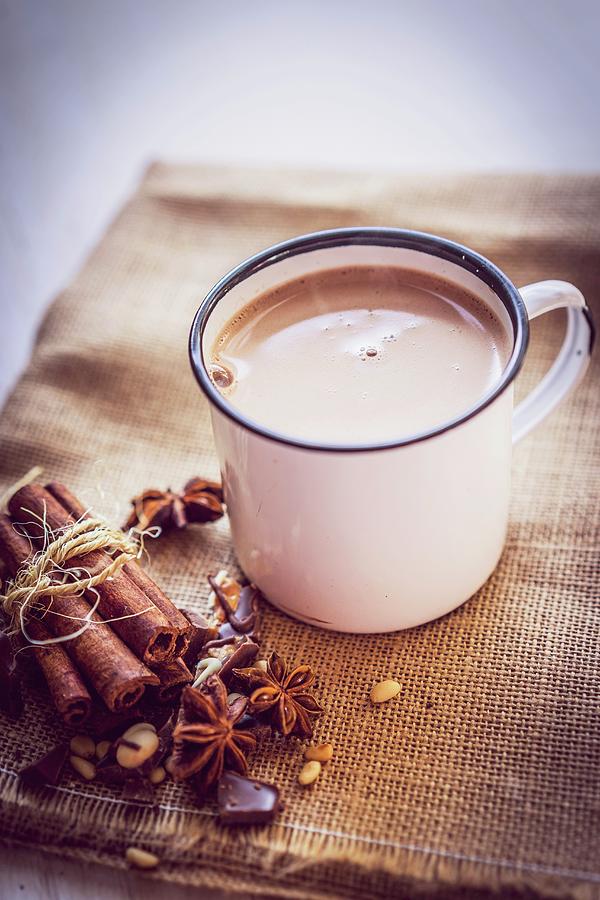 A Mug Of Hot Chocolate On A Piece Of Jute With Christmas Spices Photograph by Alena Haurylik