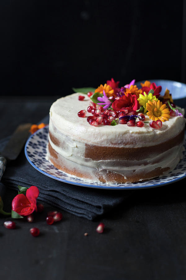 A naked Cake With Edible Flowers And Pomegranate Seeds Photograph by Lilia Jankowska