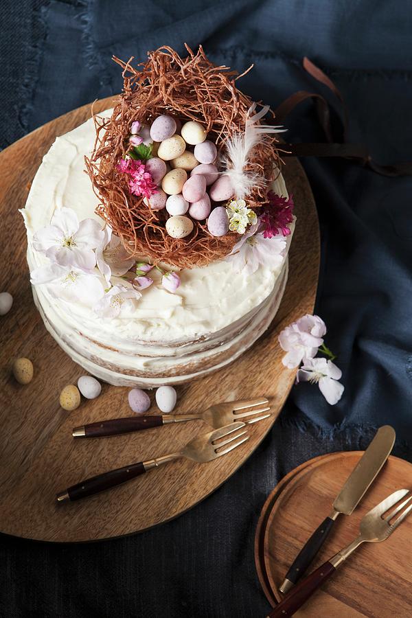 A Naked Sponge Cake Decorated With An Easter Nest, Chocolate Eggs, And Blossoms Photograph by Stacy Grant
