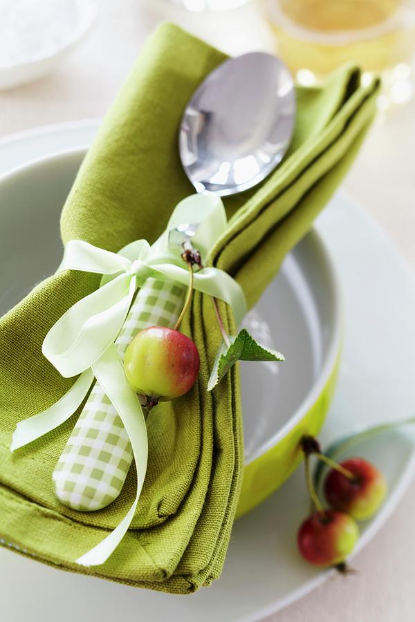 A Napkin And A Spoon Tied Together With A Ribbon And Decorated With An Ornamental Apple Photograph by Franziska Taube