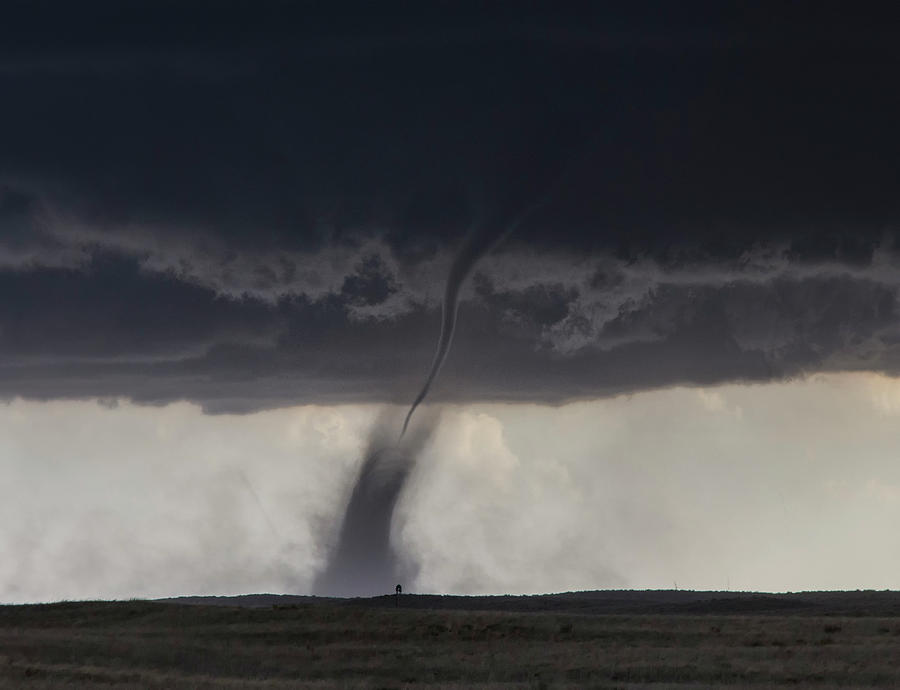 A Needle Shaped Funnel Reaches To The Ground As This Tornado Forms Over