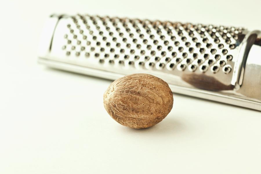 A Nutmeg With A Grater close-up Photograph by William Boch