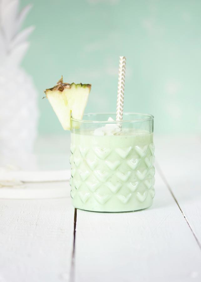 A Pale Green Pineapple Smoothie In A Glass Photograph by Emma Friedrichs