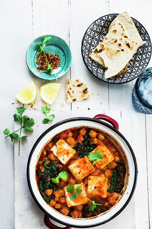 A Pan With Baked Chickpeas In Tomatoe Sauce With Kale And Tofu. Vegan Dish Served With Chapati Bread Photograph by Maricruz Avalos Flores