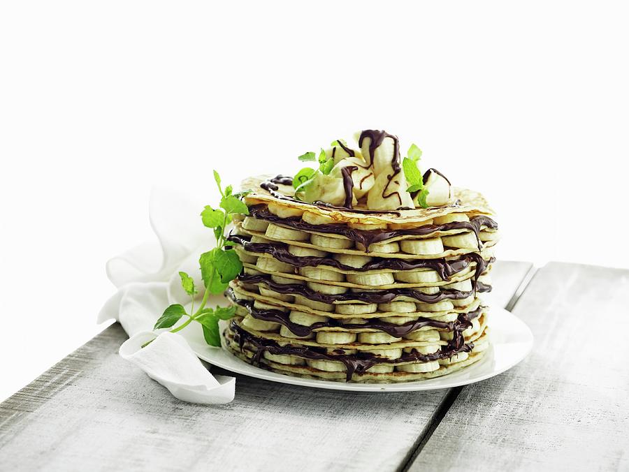 A Pancake Cake With Bananas And Nut And Nougat Cream Photograph by Mikkel Adsbl