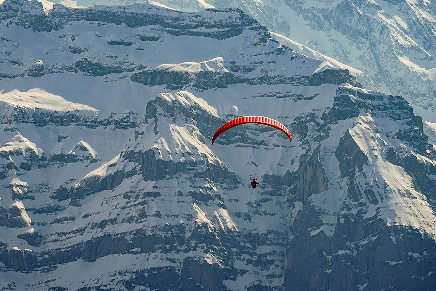 A paraglider in flying in Jungfrau region in Switzerland. Photograph by George Afostovremea