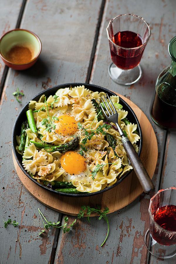 A Pasta Dish With Asparagus And Fried Eggs Photograph by Ewgenija Schall