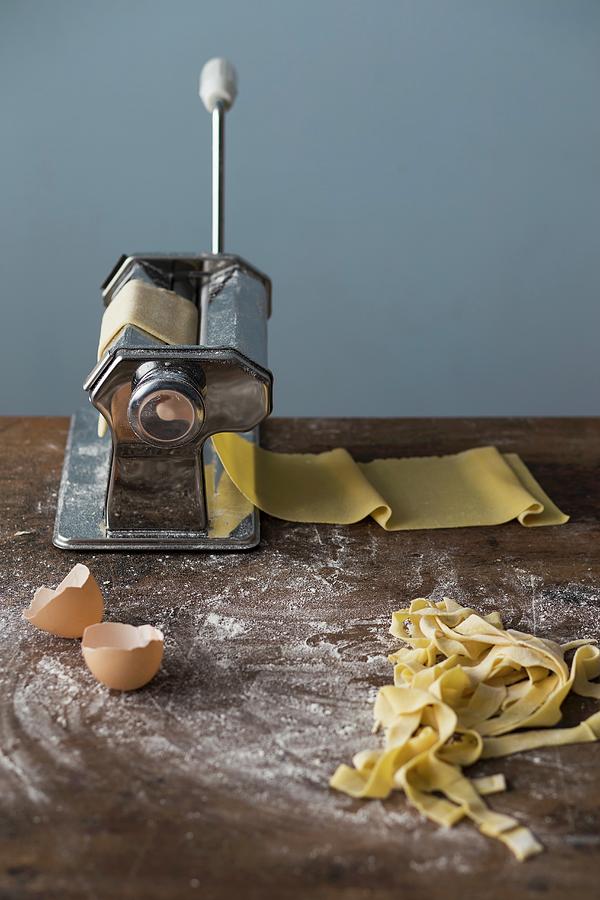 A Pasta Machine With Fresh Pasta Dough And Homemade Tagliatelle Photograph by Malgorzata Laniak