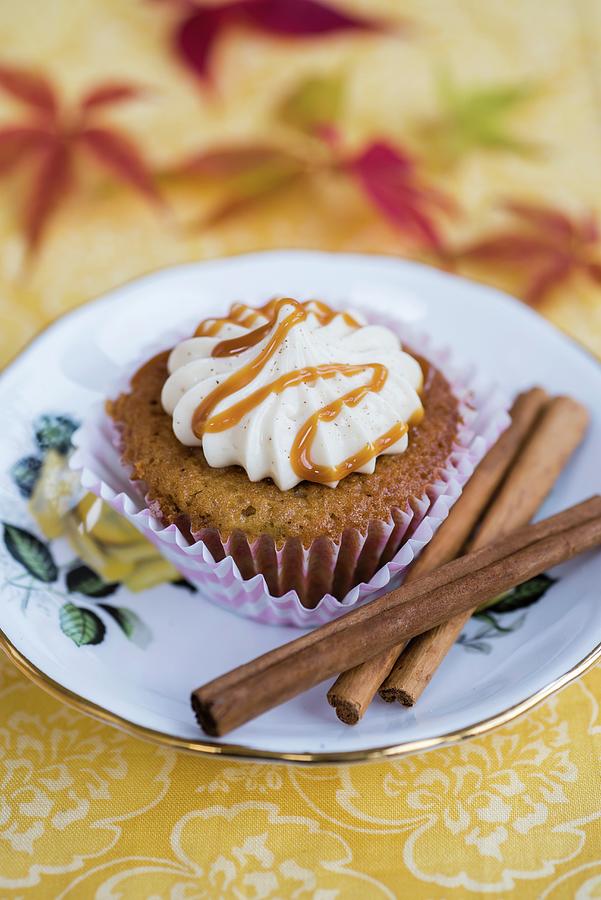 A Pear And Spice Cupcake With Cream Cheese Frosting And Caramel Photograph by Lucy Parissi