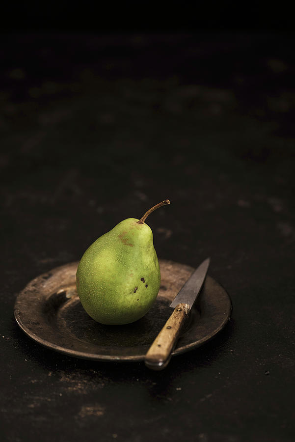 A Pear On A Tin Plate With A Knife Photograph by M. Nlke