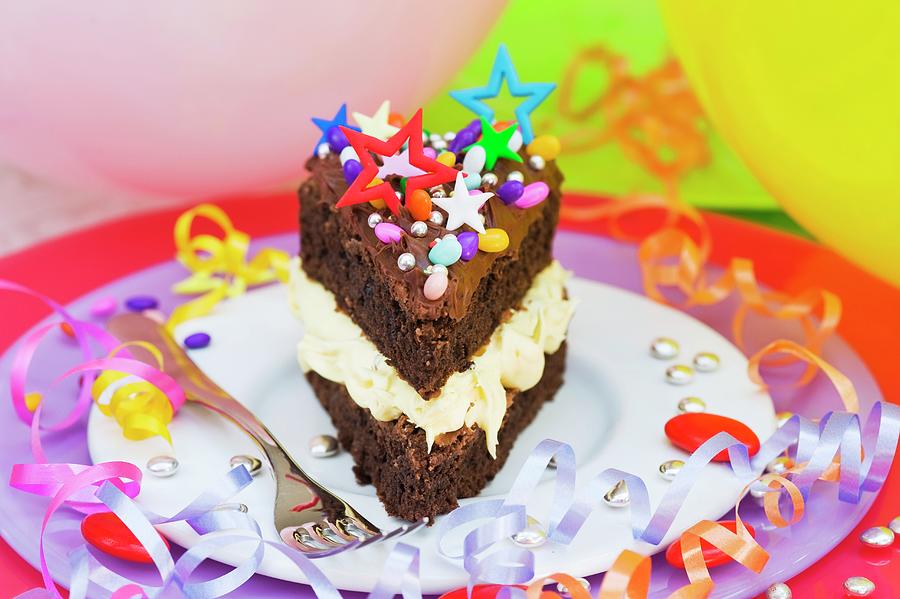A Piece Of Chocolate Cake With Colorful Sprinkles And Candy Decorations For A Party Photograph by Burgess, Jasmine