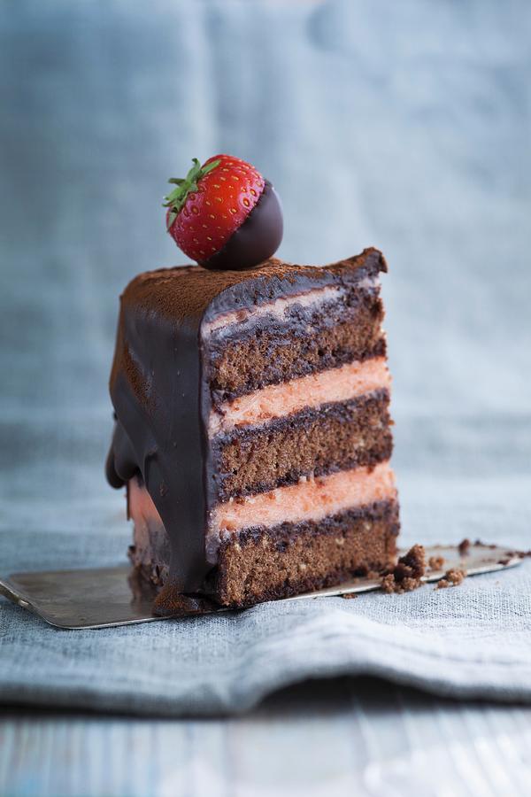 A Piece Of Chocolate Sponge Cake With Strawberries Photograph by Eising Studio