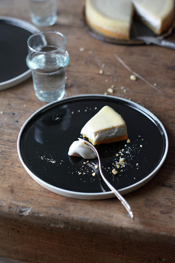 A Piece Of Vegan New York Cheesecake On A Black Plate Photograph by Pilar Felix