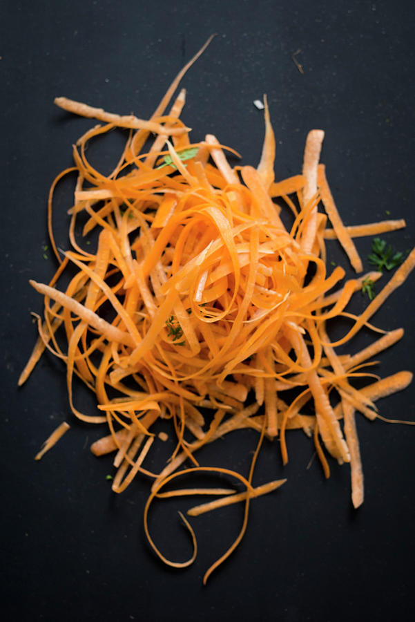 A Pile Of Carrot Peel On A Black Background Photograph by Manuela Rther
