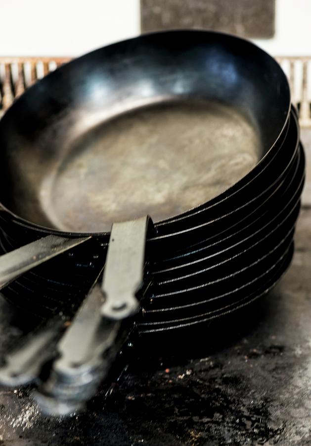 A Pile Of Empty Frying Pans Photograph by Hein Van Tonder