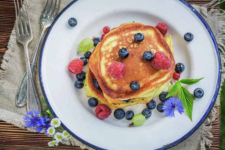 A Pile Of Pancakes With Fresh Berries And Maple Syrup seen From Above Photograph by Shaiith