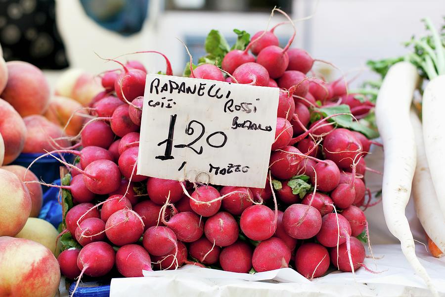 A Pile Of Radishes At The Market With A Price Sign Photograph by Arras, Klaus
