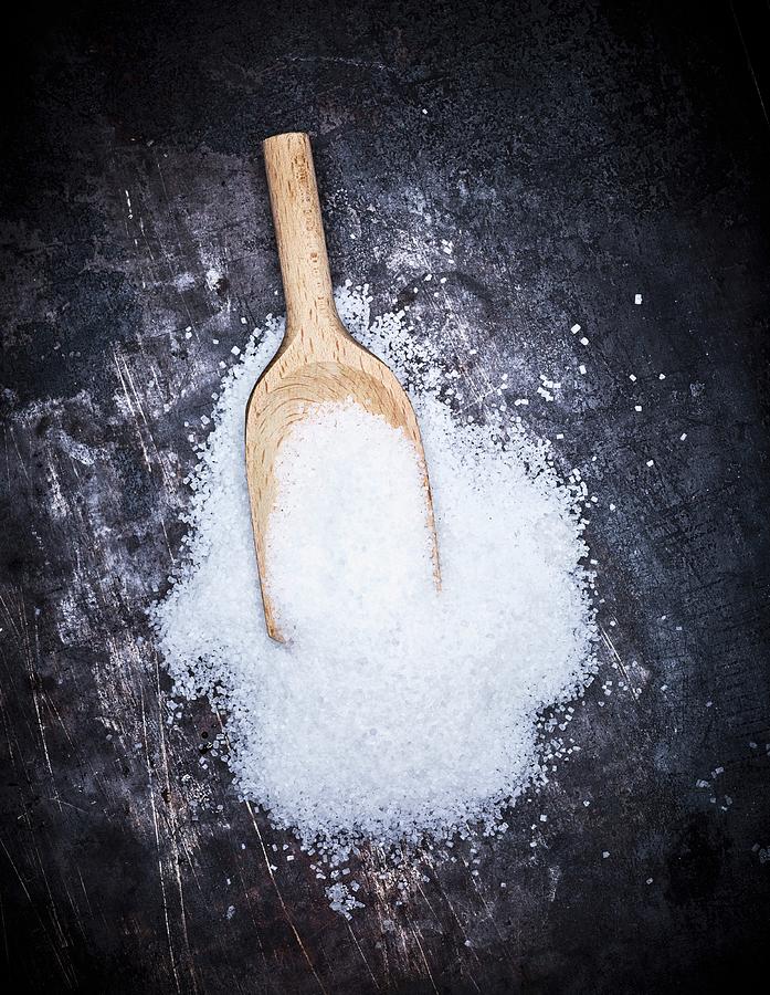 A Pile Of Sugar With A Wooden Scoop Photograph by Peter Rees