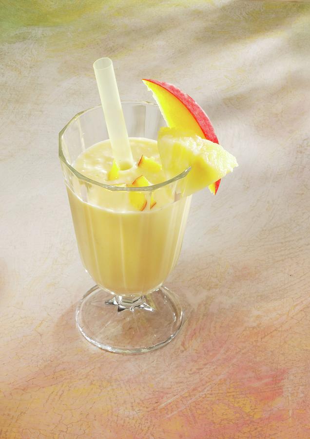 A Pineapple And Ginger Smoothie With Mango And Almond Milk Photograph by Karl Newedel
