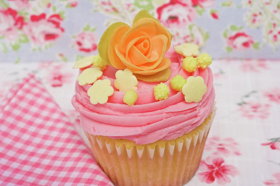 A Pink Cupcake Decorated With A Sugar Rose And Sweets Photograph by Linda Burgess