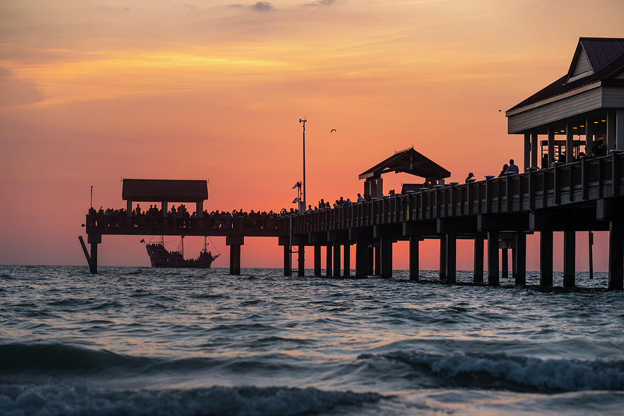 A Pirate Ship sales past the Clearwater Pier at Sunset Florida Photograph by Toby McGuire