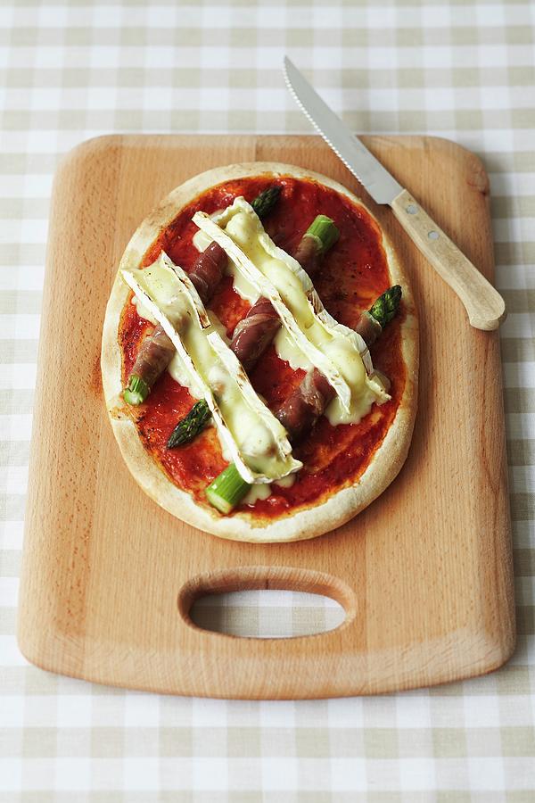 A Pizza Spread With Tomato Pure And Topped With Proscuitto Wrapped Asparagus And Melted Cheese Photograph by Charlotte Tolhurst