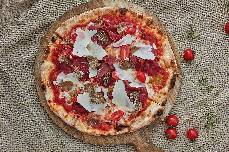 A Pizza With Tomato Sauce, Mozzarella, Bresaola, Truffles And Parmesan Cheese Photograph by Liv Friis
