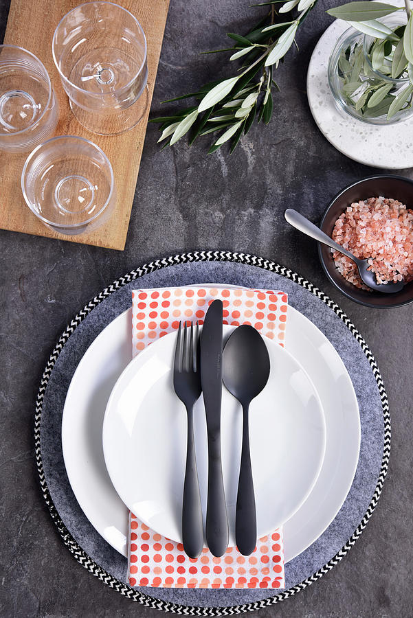 A Place Setting With A Grey Plate, White Plates And Black Cutlery Photograph by Great Stock!