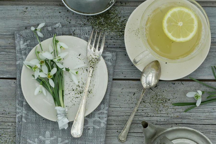 A Place Setting With Snowdrops And A Cup Of Bergamot Tea Photograph by Martina Schindler