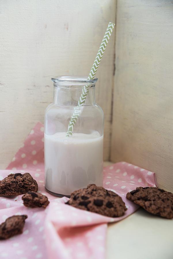 A Plant-based Drink In A Glass Bottle With Vegan Chocolate Cookies Next To It Photograph by Kati Neudert