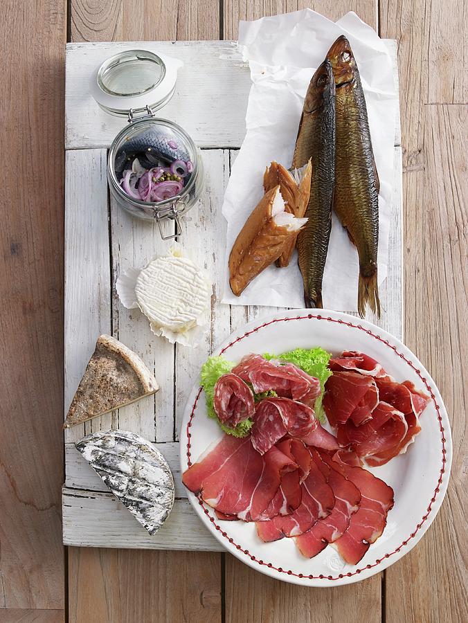 A Plate Of Cold Cuts Featuring Salami, Raw Ham, Smoked Fish And Cheese For Brunch Photograph by Jan-peter Westermann