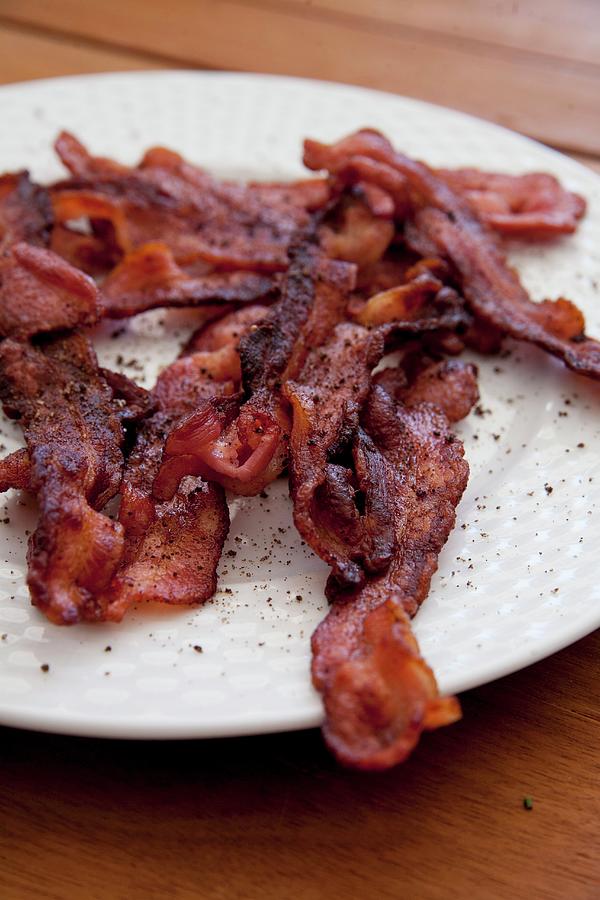 A Plate Of Crispy Fried Bacon Photograph by Claudia Timmann