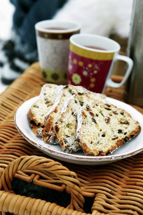 A Plate Of Stollen Cake And Cups Of Hot Drinks On Top Of A Picnic Basket In The Open Air Photograph by Jalag / Olaf Szczepaniak