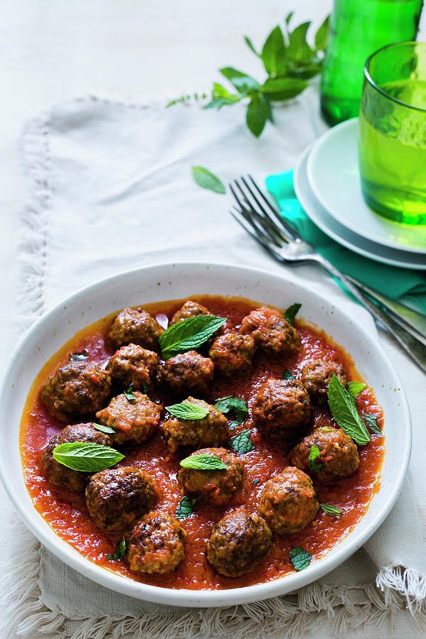 A Plate With Greek Lamb Kofta In Tomatoe Sauce With Mint Leaves Photograph by Maricruz Avalos Flores
