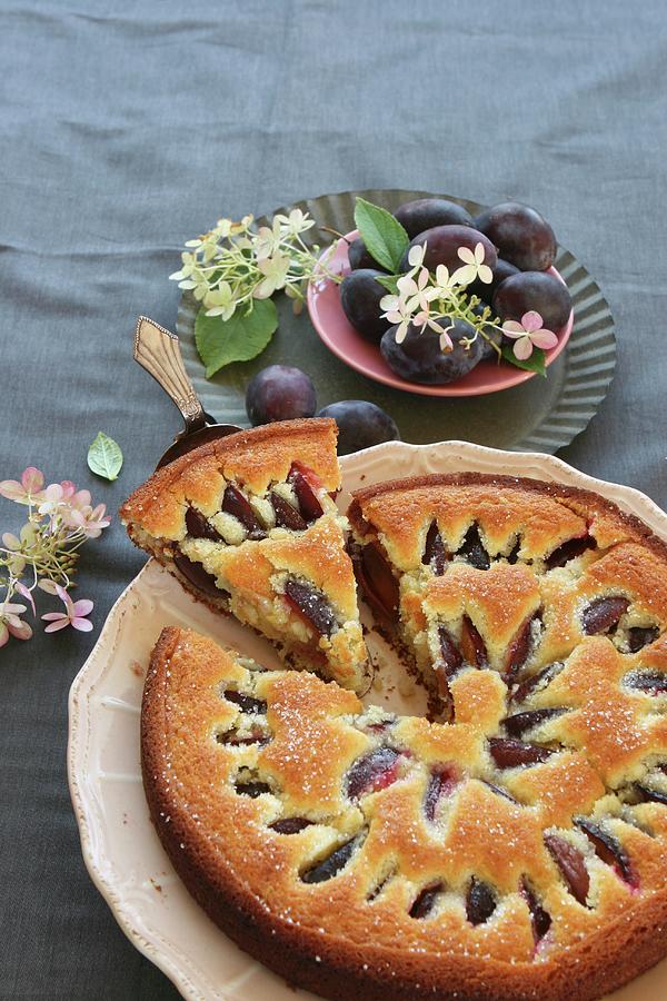 A Plum Cake With A Piece On A Cake Slice Photograph by Regina Hippel