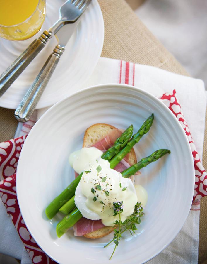 A Poached Egg On A Slice Of Bread And Ham With Green Asparagus And Hollandaise Sauce Photograph by Farrell Scott