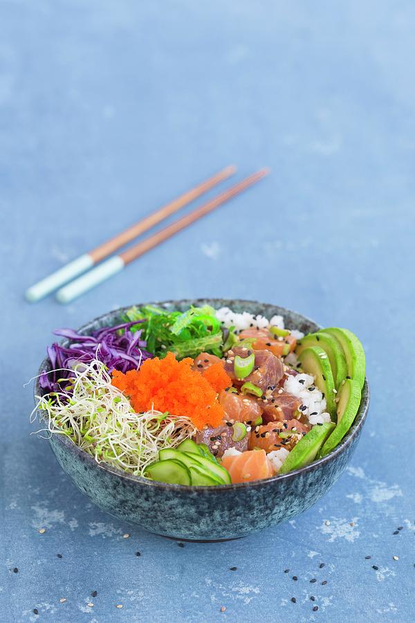 A Poke Bowl With Wakame Seaweed, Tuna, Sushi Rice, Salmon, Alfalfa Sprouts, Red Cabbage, Sesame Seeds, Cucumber Slices, Spring Onions, Avocado, And Tobiko Photograph by Tina Engel