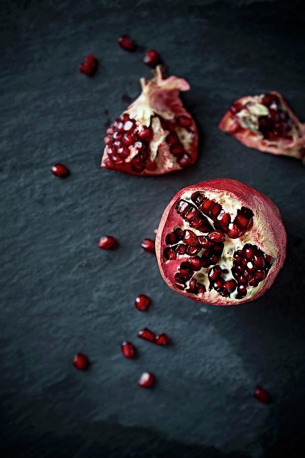 A Pomegranate On A Black Slate Platter Photograph by B.&.e.dudzinski