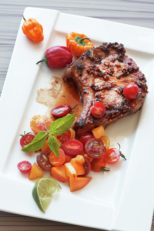 A Pork Chop With Tomato Salsa, Peaches And Peppers Photograph by Rose Hodges