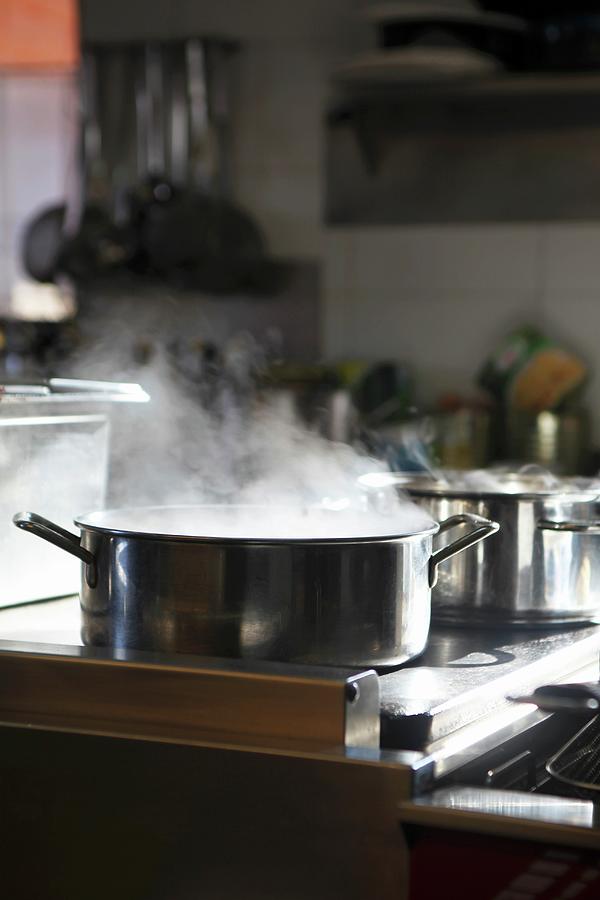 A Pot Of Steaming Water On A Stove Photograph by Ludger Rose