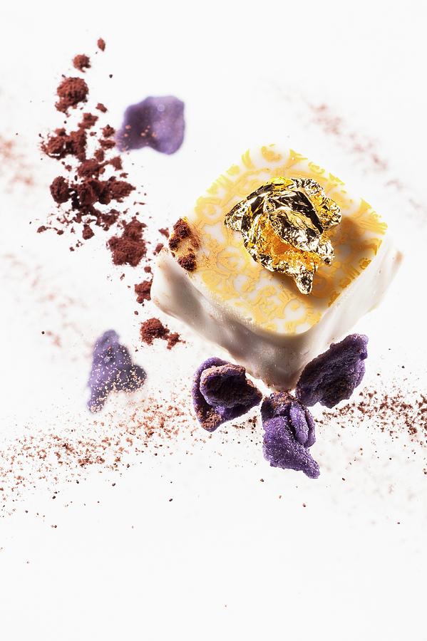 A Praline With Gold Leaf And Candied Violets Photograph by Michael Schinharl