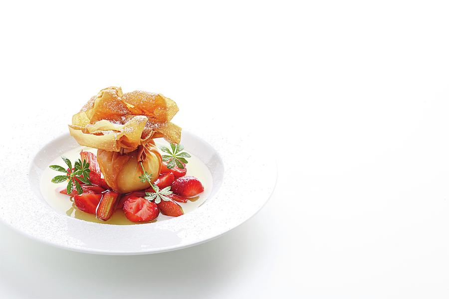 A Quark-filled Strudel Pastry Pocket On A Bed Of Rhubarb And Strawberries In Woodruff Jus Photograph by Jalag / Mathias Neubauer